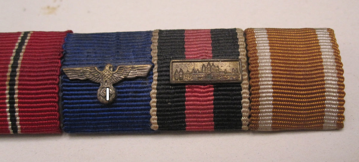 5er Feldspange Kriegsverdienstkreuz 2.Klasse mit Schwertern, Ostmedaille; Dienstauszeichnung der Wehrmacht; Spange Prager Burg , Schutzwallmedaille